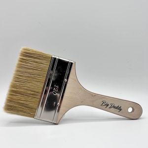 May include: A wooden-handled paint brush with natural bristles. The brush is labelled "Big Daddy" and "120".