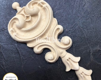May include: A wooden decorative scroll with intricate details, featuring a swirl design and a pointed bottom. The scroll is unpainted and has a light brown color.