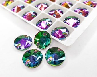 May include: Iridescent round rhinestones in shades of green, purple, and blue. Some rhinestones are arranged in a white tray, while others are scattered on a white surface. These decorative gems are perfect for crafts and embellishments.