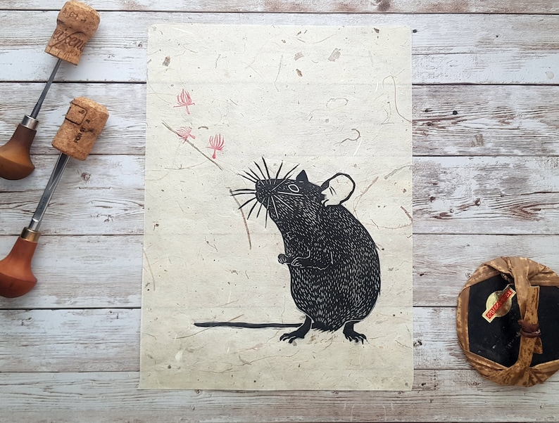May include: Black and white illustration of a mouse with a long tail, standing on its hind legs and sniffing a pink flower. The illustration is on a textured, off-white paper.