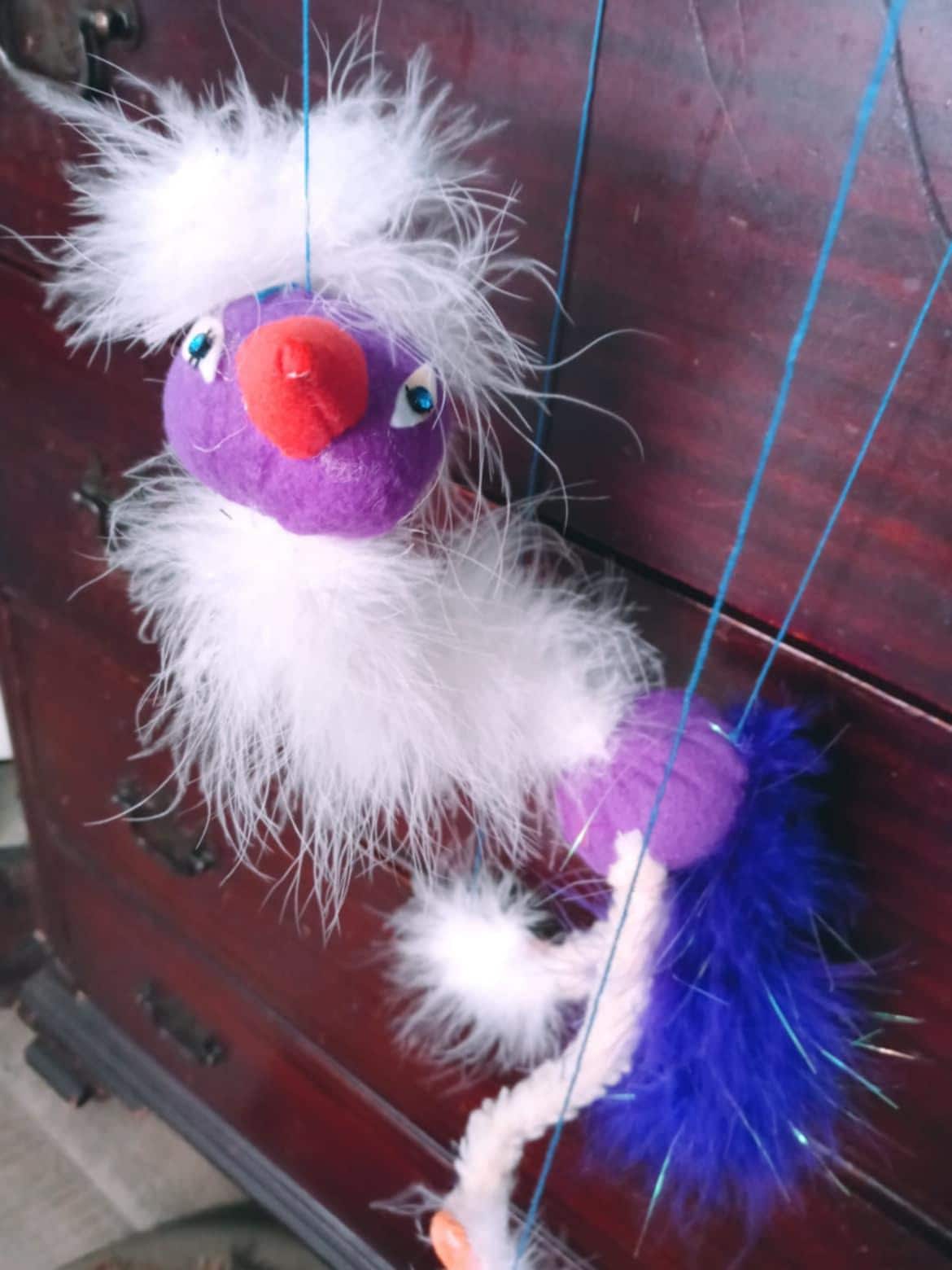 Bird string puppets in beautiful pastel colors.