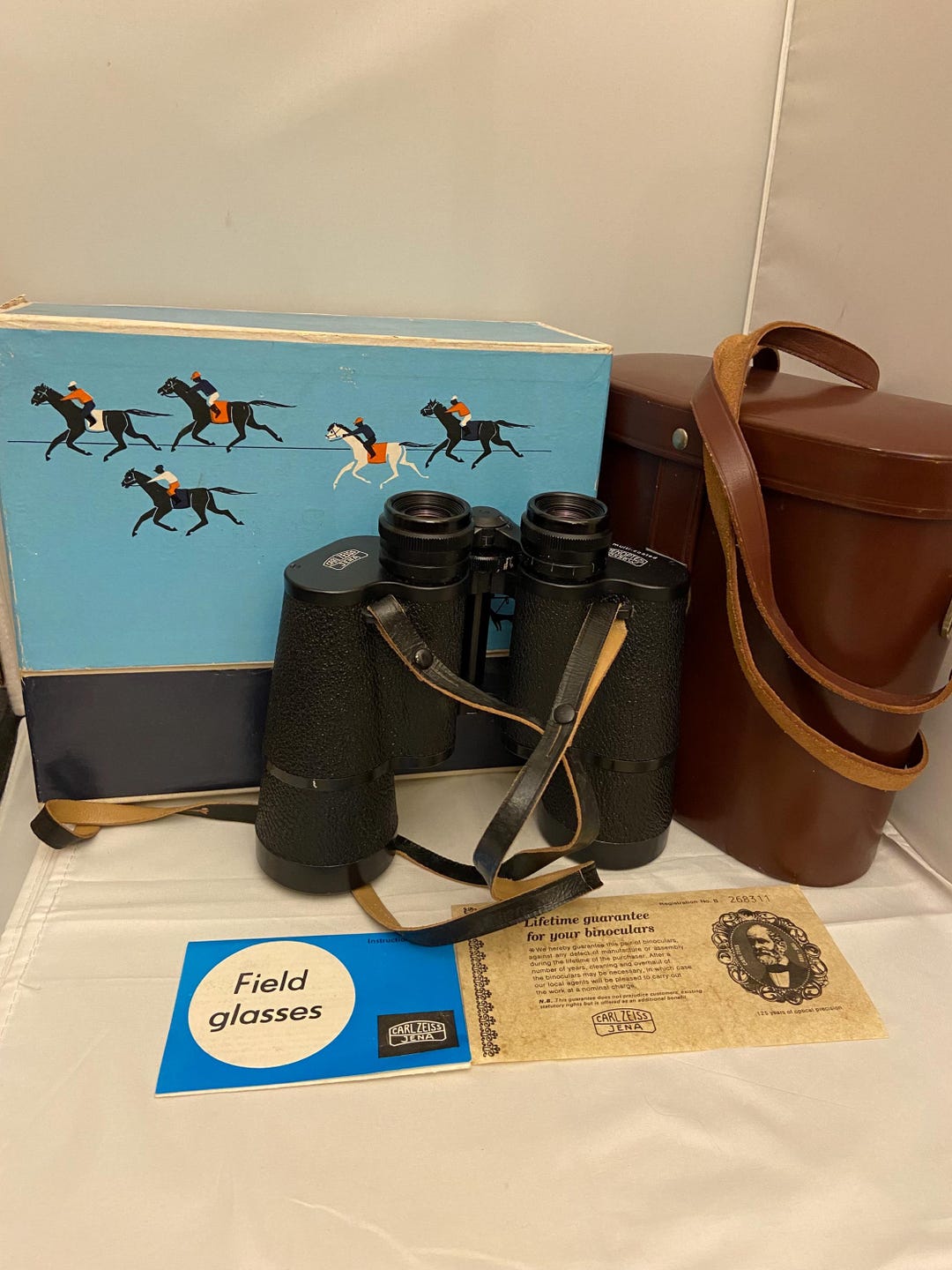 A cased pair of Carl Zeiss Jenoptem 10x50w binoculars