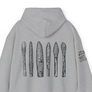 May include: Gray hooded sweatshirt with a black print of seven stylized arrows on the back. The right sleeve has a black print of "NOT CIVILIZED" in all caps.