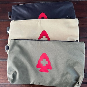 May include: Three zippered pouches in black, beige, and green with a red logo of a stylized tree with a plus sign on the front.