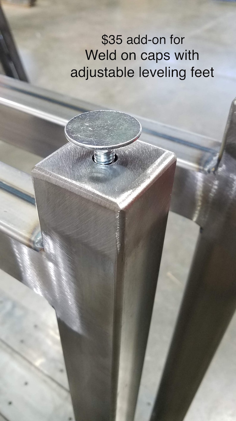 May include: Close-up of a silver metal adjustable leveling foot with a screw. The foot is attached to a square metal leg. The text "$35 add-on for Weld on caps with adjustable leveling feet" is visible above the foot.