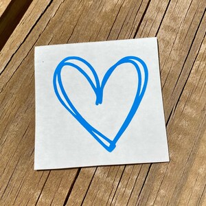 May include: A blue heart drawn on a white background. The heart is a simple, hand-drawn design with a double outline.