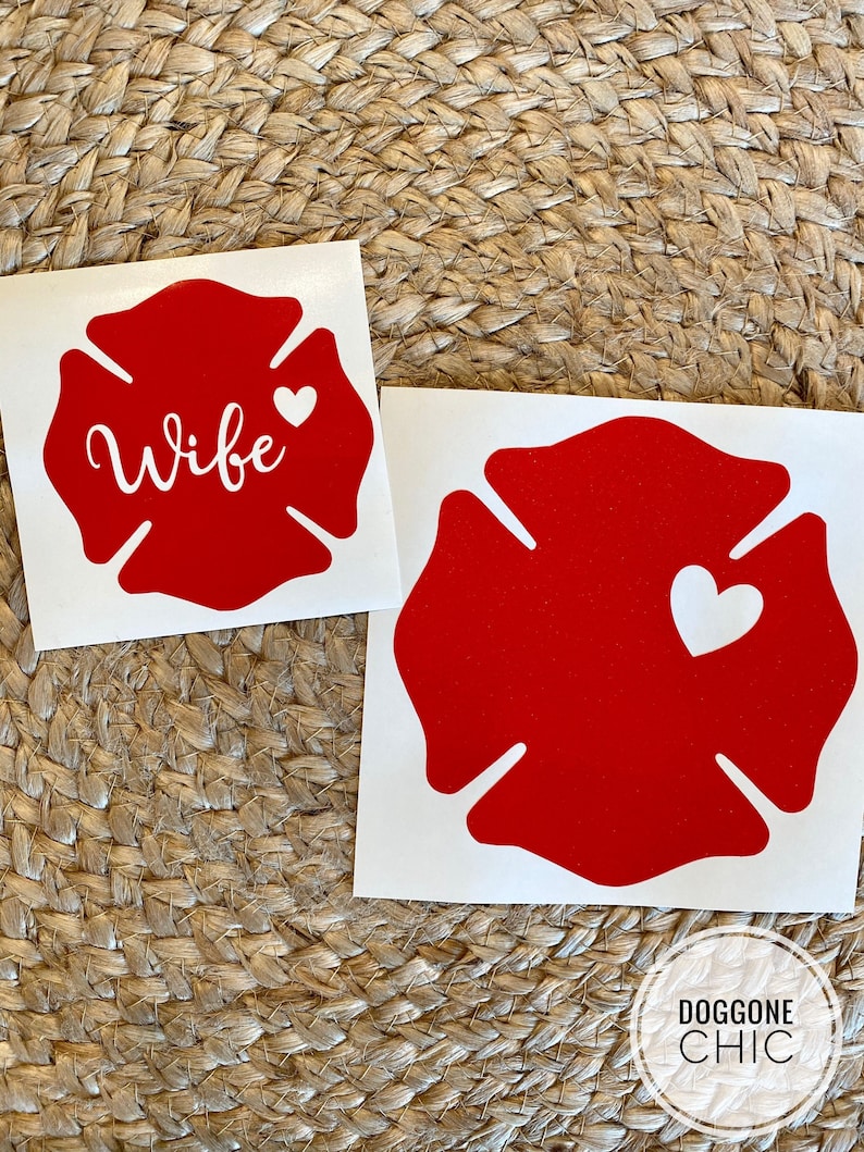 May include: Two red firefighter's helmet decals. One decal says "Wife" with a small white heart. The other decal has a white heart.