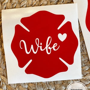 May include: Red fire hydrant sticker with the word "Wife" in white cursive lettering and a small white heart.