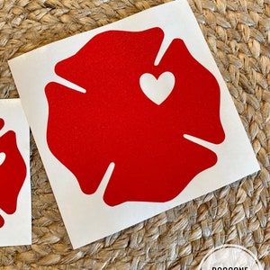 May include: Red vinyl decal of a fire hydrant with a white heart in the centre. The decal is on a white background.