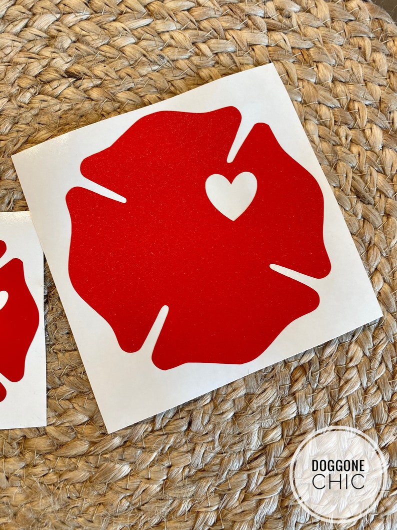 May include: Red vinyl decal of a fire hydrant with a white heart in the centre. The decal is on a white background.
