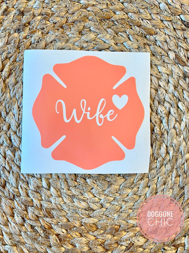 May include: A coral-coloured firefighter's helmet decal with the word "Wife" and a small white heart.
