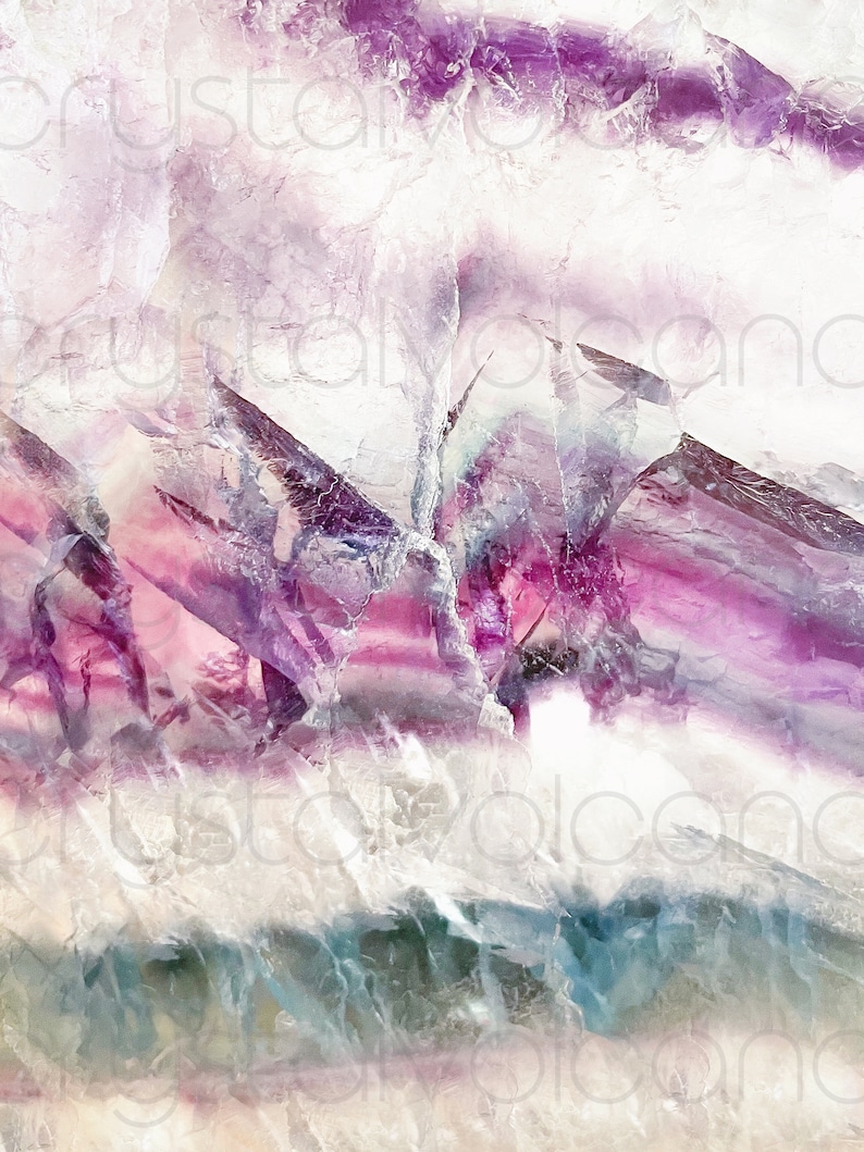 May include: Close-up of a purple, pink, and white fluorite crystal with a layered, striated pattern. The crystal has a translucent, almost iridescent quality.