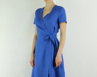May include: A royal blue wrap dress with short sleeves and a tie at the waist.
