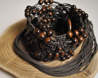 Wide Macrame Fringed Belt Made Of Natural Cotton Rope In Brown Color And Decorated With Brown Wood Beads And a Wooden Buckle