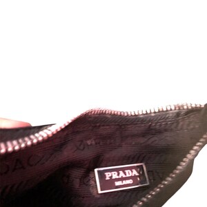 May include: Black zippered pouch with a Prada Milano label inside.