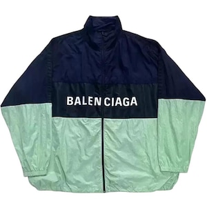 May include: A black and green windbreaker jacket with a white "BALENCIAGA" logo on the front.