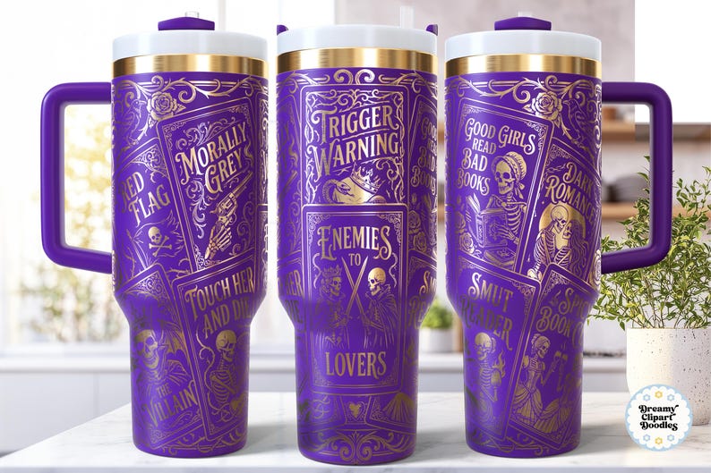 May include: Purple travel tumbler with gold-colored illustrations and text. The tumbler features phrases like "Trigger Warning" and "Enemies to Lovers." The design includes images of skeletons, guns, and playing cards. It has a purple handle and a white and gold lid.