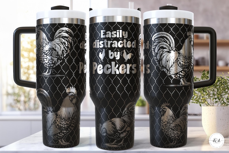 May include: Black travel mug with a silver rooster design and the text "Easily distracted by Peckers". The mug has a black handle, a white lid, and a silver rim. The design is set against a chain-link fence pattern.