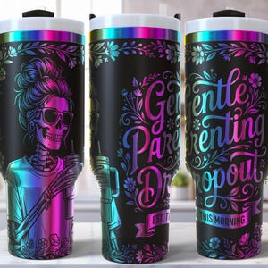May include: Black travel tumbler with a wraparound design featuring a skeleton wearing sunglasses and holding a drink. The tumbler has a black handle and lid, with the words "Gentle Parenting Dropout" in colorful script. Floral accents complete the design.
