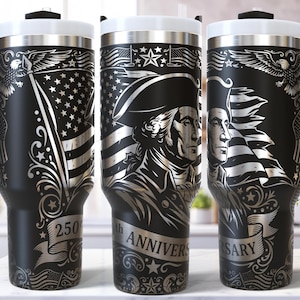 May include: Black travel mugs with silver engraved designs. The mugs feature American flags, eagles, and portraits of George Washington. The text "250th Anniversary" is also displayed. Each mug has a black handle and a silver lid.