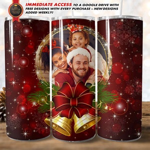 May include: A red and white Christmas-themed tumbler featuring a family photo within a gold frame. The design includes snowflakes, a red bow, and gold bells. The text reads "IMMEDIATE ACCESS TO A GOOGLE DRIVE WITH FREE DESIGNS WITH EVERY PURCHASE - NEW DESIGNS ADDED WEEKLY!"