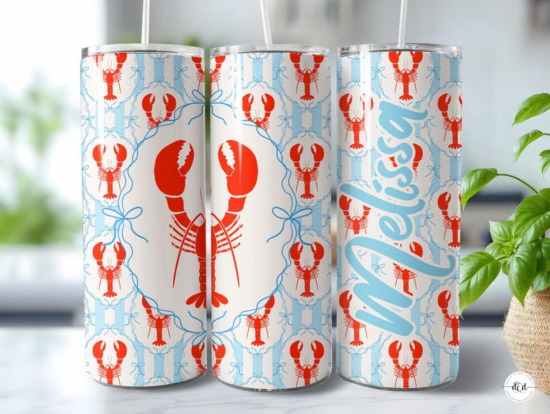May include: A set of three stainless steel tumblers with a lobster design. The tumblers feature a repeating pattern of red lobsters on a white and light blue striped background. One tumbler has the name "Melissa" in light blue.
