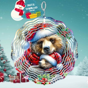 May include: A metal wind chime featuring a brown bear and a cub wearing red and white plaid scarves and Santa hats. The wind chime is circular and has a swirling design. The background is a snowy winter scene.