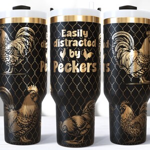May include: Black travel mug with a gold rooster design and the text "Easily distracted by Peckers". The mug has a black handle, a white lid, and a gold rim. The rooster design is repeated around the mug.