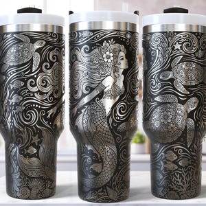 May include: A set of three ceramic mugs with a speckled, matte finish. The mugs are in shades of cream, light gray, and dark gray. Each mug has a simple, minimalist design, perfect for coffee or tea.