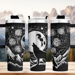 May include: Three stainless steel tumblers with a black and white design of a wolf howling at the moon in a starry night sky. The tumblers have a black lid and a black handle.