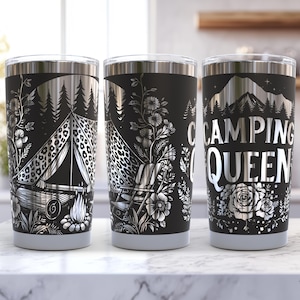 May include: Three stainless steel tumblers with black and silver designs. The tumblers feature different camping-themed illustrations, including a tent, a campfire, and a mountain range. One tumbler has the text "Camping Queen" printed on it.