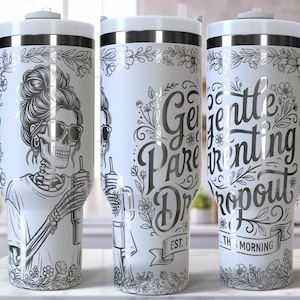 May include: White tumbler with a wraparound design featuring a skeleton wearing sunglasses and holding a drink. The tumbler also has the words "Gentle Parenting Dropout" and floral accents. It has a white handle and lid.