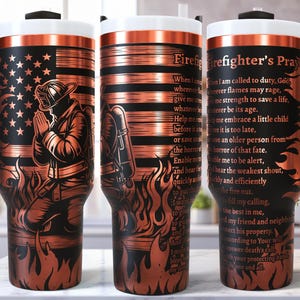 Puede incluir: Un vaso de color cobre con asa y tapa negras. El diseño presenta una bandera estadounidense, un bombero arrodillado y llamas. El texto en el vaso dice "Firefighter's Prayer".