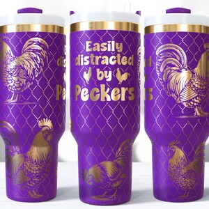 May include: A purple travel mug with a white lid and handle, featuring a gold rooster design and the text "Easily distracted by Peckers." The mug has a diamond pattern background.