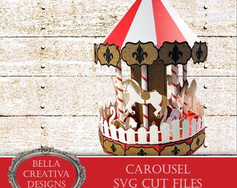 May include: A red and white striped carousel with gold accents and a white horse. The carousel is decorated with gold fleur-de-lis and has a white picket fence around the base. The text "CAROUSEL SVG CUT FILES" is printed on a red banner below the carousel.
