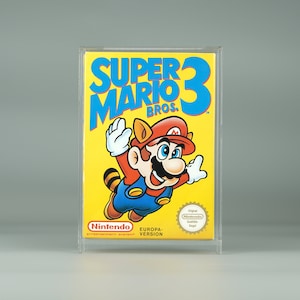 May include: A yellow, blue and red Super Mario Bros. 3 video game cartridge in a clear plastic case. The game features a cartoon image of Mario in a raccoon suit.