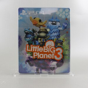 May include: A blue, orange, and white video game case for LittleBigPlanet 3 for the Playstation 4. The case features a blue, furry monster, a green, dinosaur-like creature, a yellow bird, and a small, brown character with a red hat.