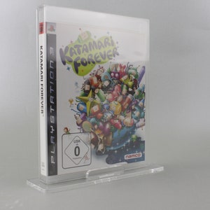 May include: A clear plastic case holds a video game for the Playstation 3. The game is Katamari Forever. The cover art features a colorful cartoon image of a large ball with many smaller balls attached to it. The game is rated 0 by the USK.