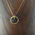 Golden Circle Necklace with Lava Rock product logo