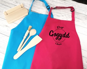 Personalised children's Welsh Prif gogydd apron in pink or blue with choice of coloured detail