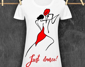 May include: White t-shirt featuring a black and red illustration of a dancing couple. The design includes a red dress and hat, with the words "Just dance!" in red script. The shirt is hanging on a clothesline.