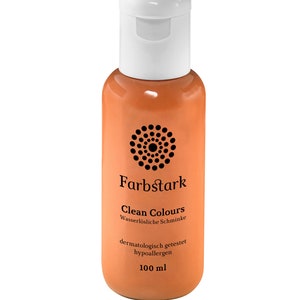 Puede incluir: Botella naranja con tapón blanco. La botella tiene el texto "Farbstark Clean Colours" y otro texto en alemán. Contiene 100 ml de producto.