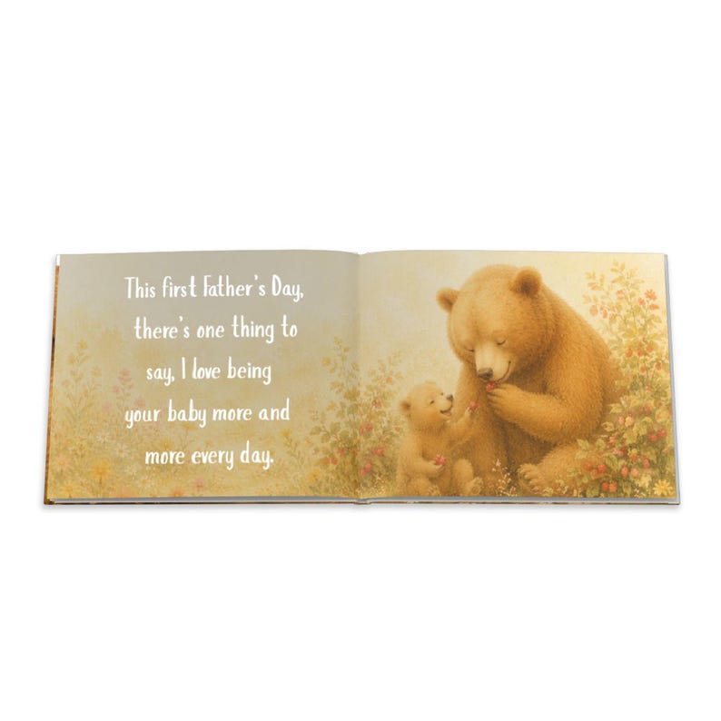 May include: An open book with a heartwarming illustration of two bears. The larger bear, with brown fur, is holding a red berry, while a smaller bear sits nearby. Text on the left page reads: "This first Father's Day, there's one thing to say, I love being your baby more and more every day."