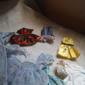 assorted doll clothes