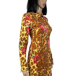 May include: A yellow, brown and red leopard print dress with long sleeves and a zip down the front.