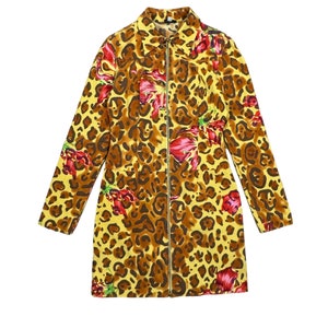 May include: A yellow, brown and red leopard print jacket with a zip closure. The jacket has a floral pattern with red flowers.