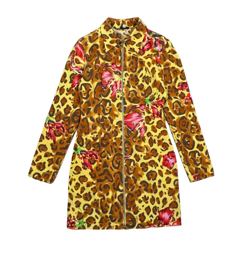 May include: A yellow, brown and red leopard print jacket with a zip closure. The jacket has a floral pattern with red flowers.