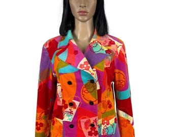 May include: A colorful double-breasted jacket with a geometric and floral print. The jacket is made of a corduroy fabric and has a  collared neckline.