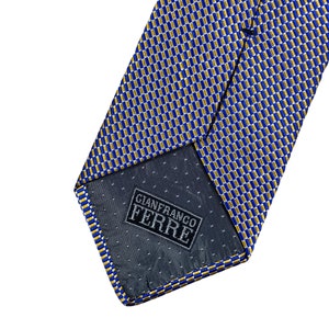 May include: Blue and gold patterned silk tie with a Gianfranco Ferre label.