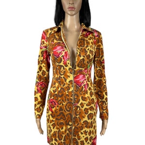 May include: A yellow, brown and red leopard print dress with a long sleeve and a zip down the front.